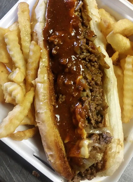 Close-up of the Boogaloo Wonderland sandwich, flanked by french fries.