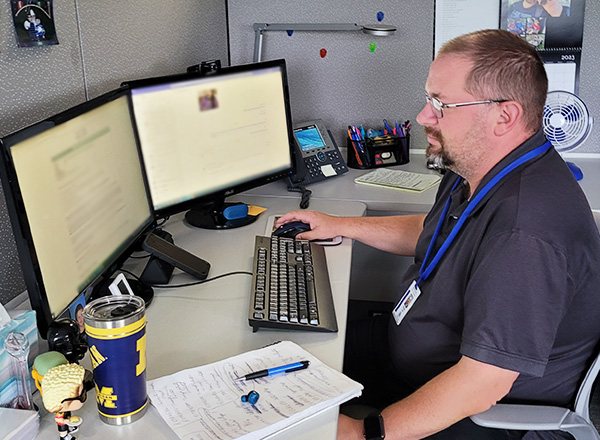 Phillip Lutz hard at work on his computer in the Welcome Center. 