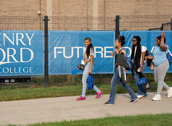 Students walk past the HFC banner.