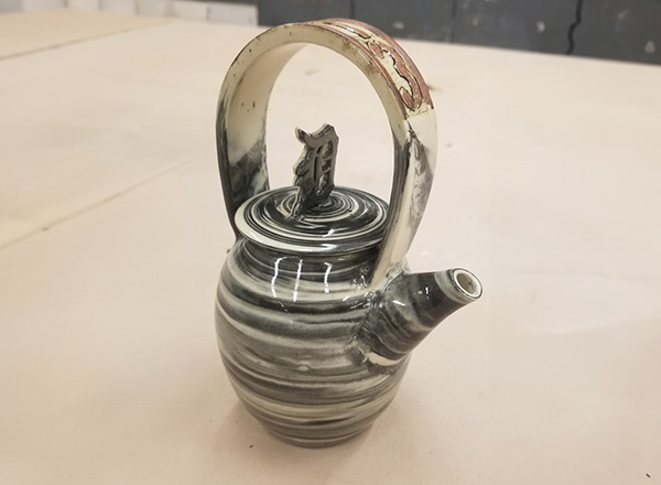 Centurium Frost sculpted this kettle that has a Detroit theme. Notice the "313" (Detroit's area code) on the handle. 