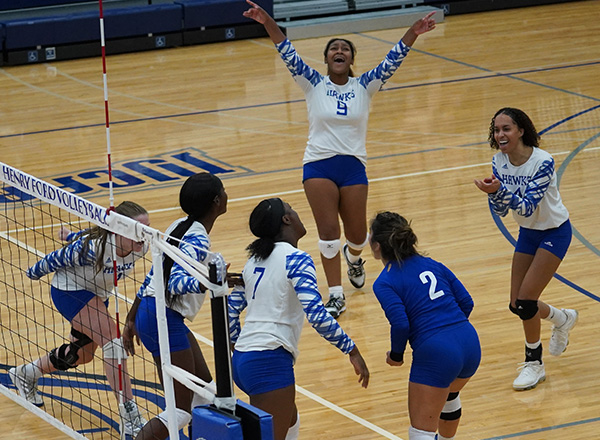 HFC Volleyball team celebrating on the volleyball court.