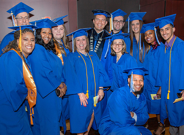 Graduates with HFC President Russ Kavalhuna.
