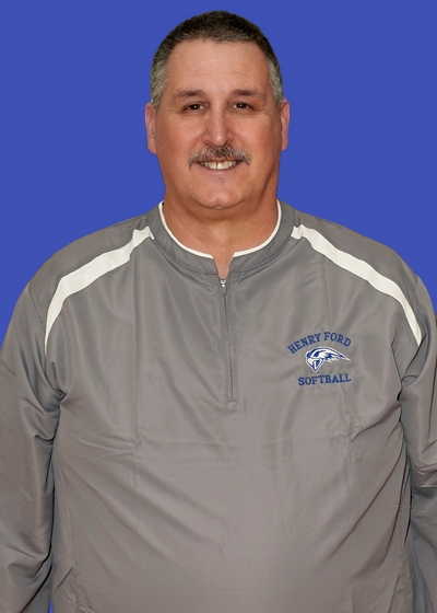 Headshot of Mike Labut on blue background