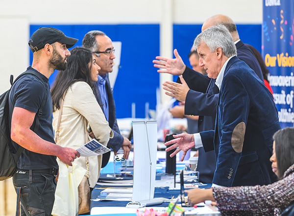 HFC student talking with an employer at one of Career Services' fairs.