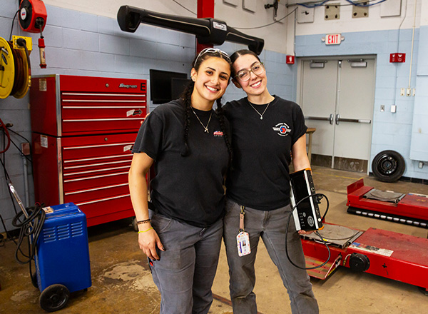 Two female students in the automotive area.