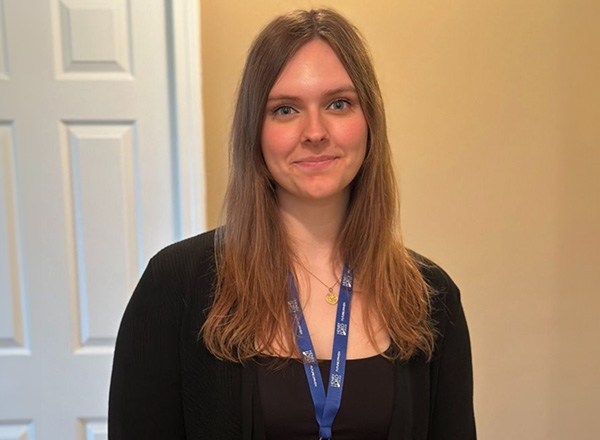 Alayna Kondraciuk has long dark blonde hair and wearing a black sweater. 