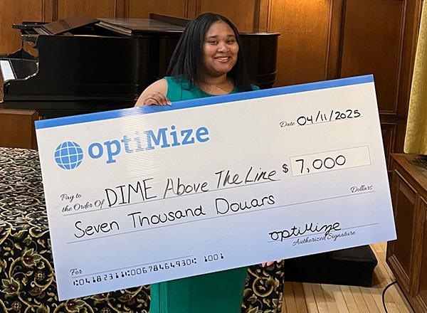 Alicia Jackson holding giant check.