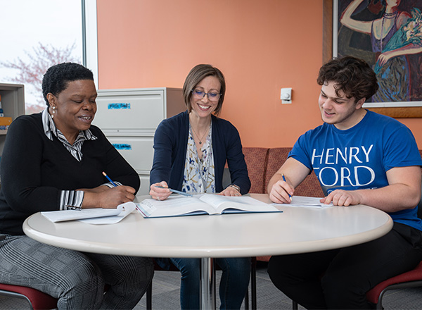 Instructor tutoring two students in the Learning Lab.