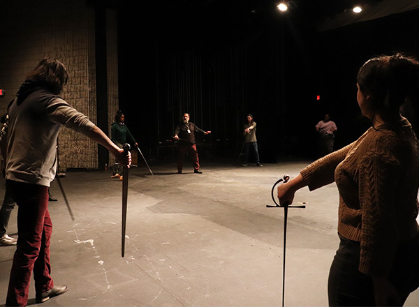HFC Theatre students and instructor practicing with swords.