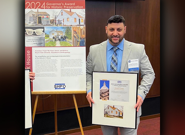 Dr. Tareq Ramadan holding the Governor's Awards for Historic Preservation.  Photo courtesy of Ramadan.