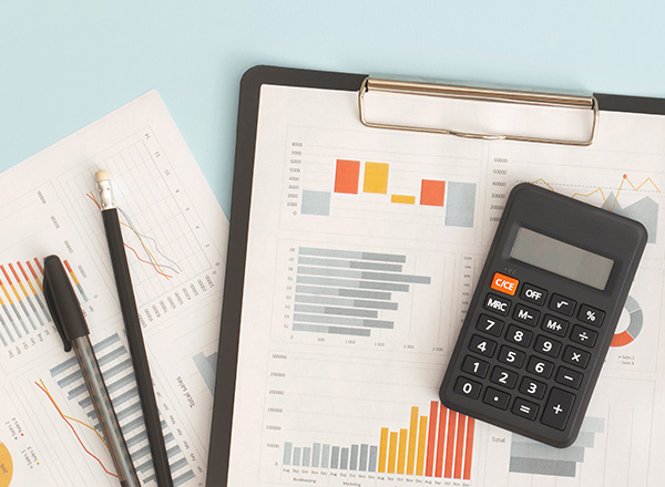 Calculator, pens, accounting papers.