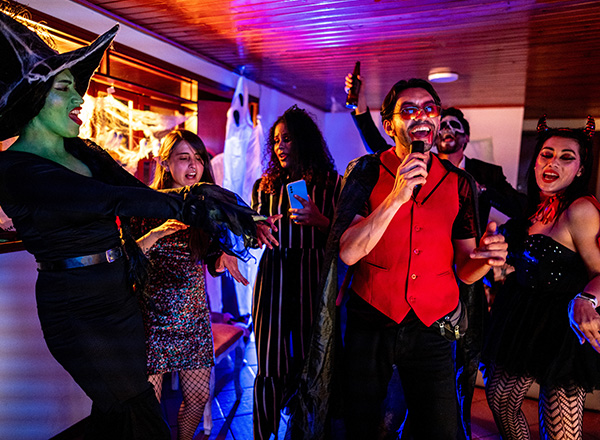 Singing karaoke with friends on a Halloween party