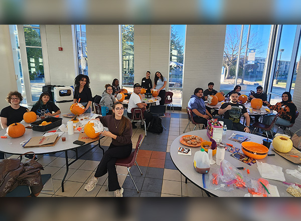 International students carving their pumpkins.