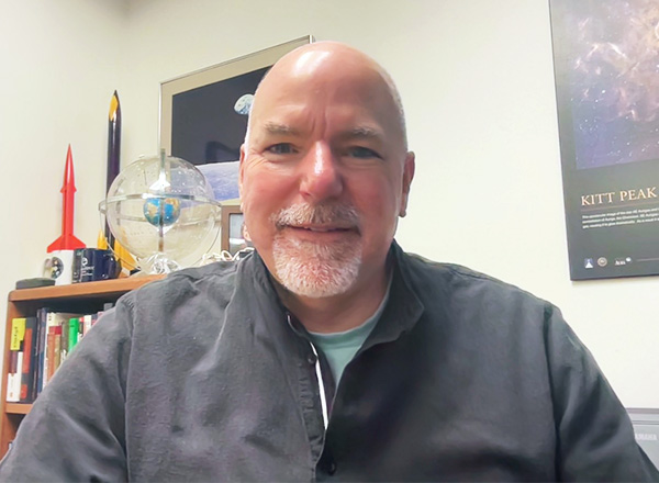 Steve Murrell selfie with science objects in his office. 