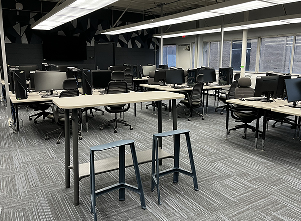 Open computer area with tables and powerful computers