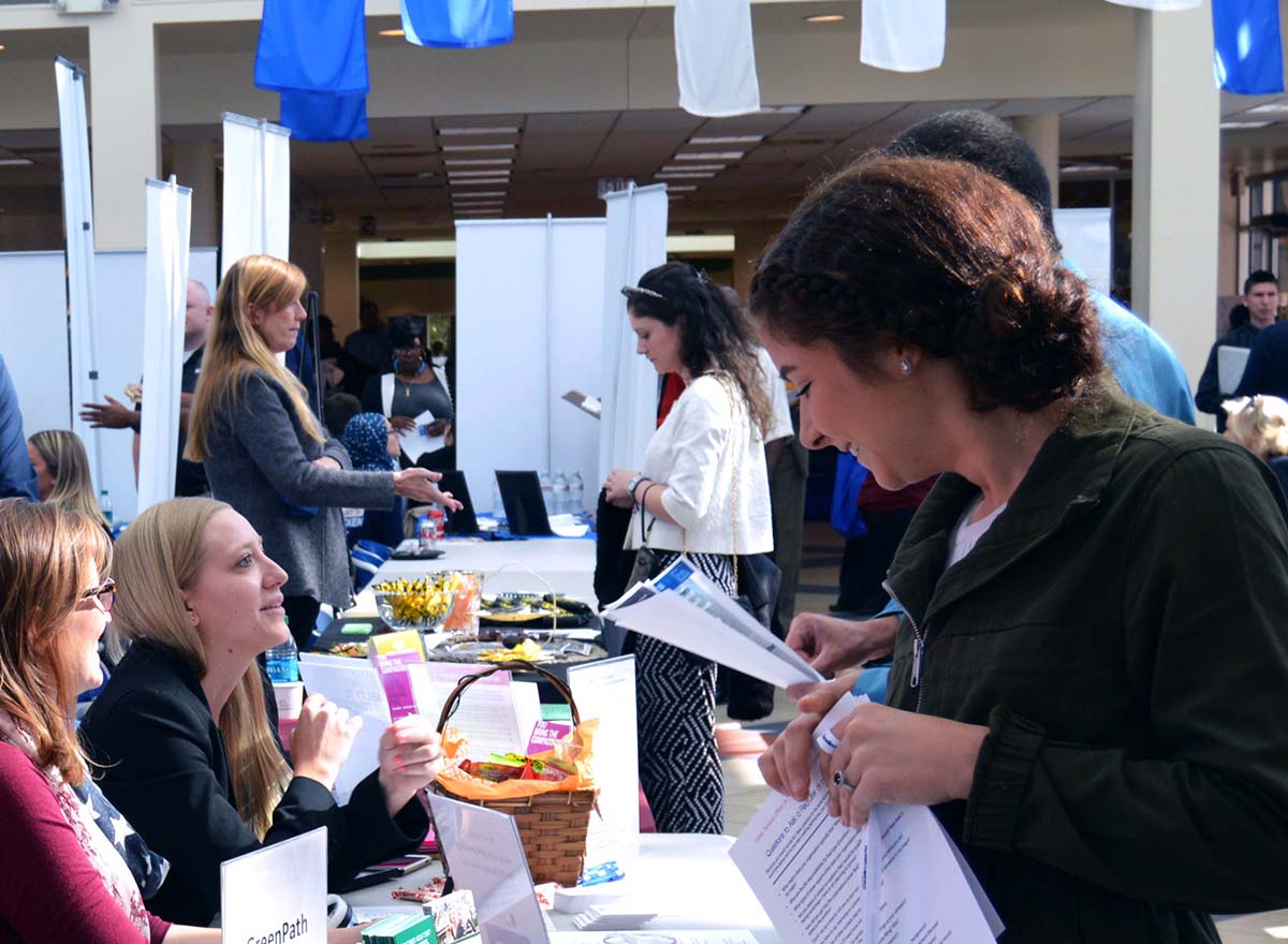 Students visiting HFC Career Expo booths, talking to potential employers