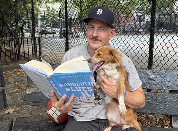 Man holding dog and reading book