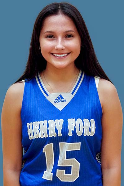 Portrait of Alayna Jacobs in blue Henry Ford jersey on blue background