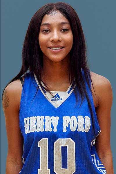 Portrait of Tanaizah Coleman in blue Henry Ford jersey on blue background
