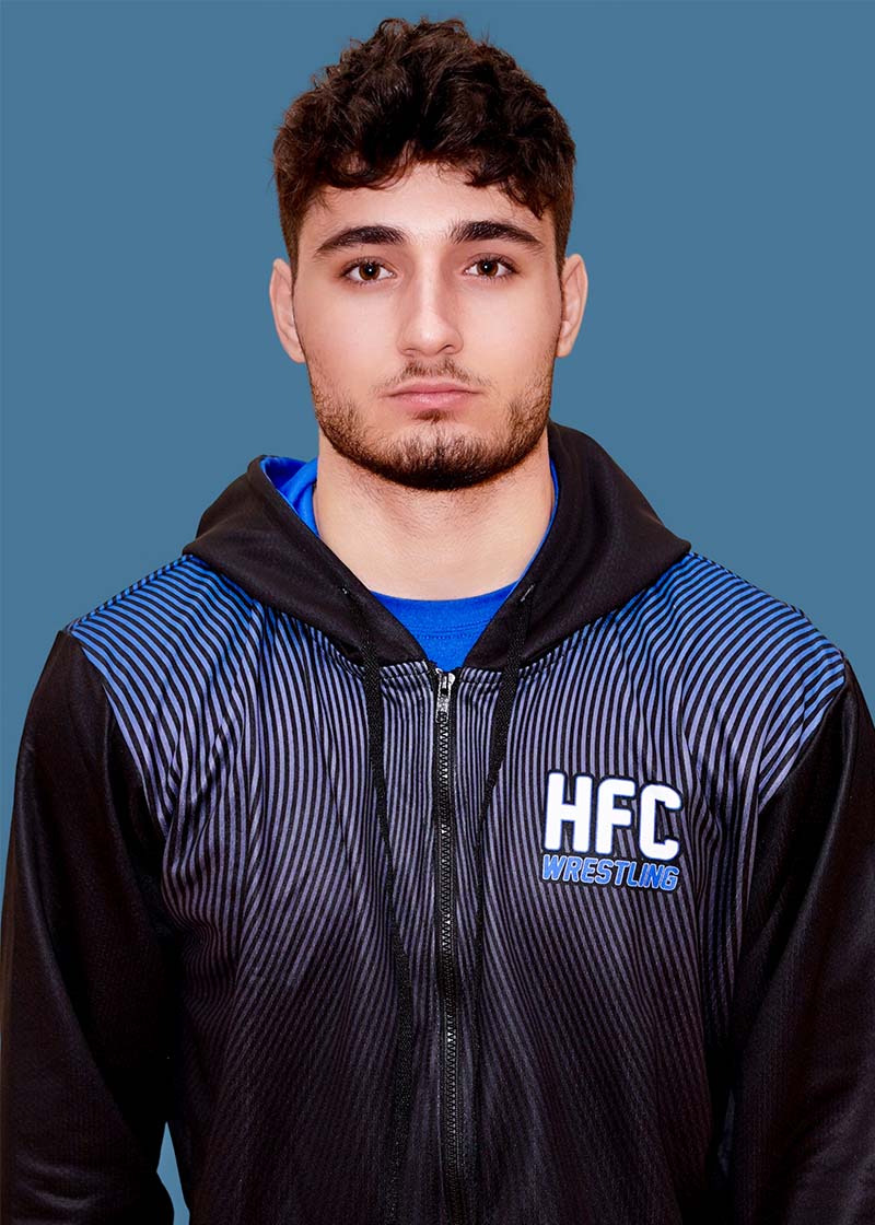 Portrait of Ameer Chehab against blue background