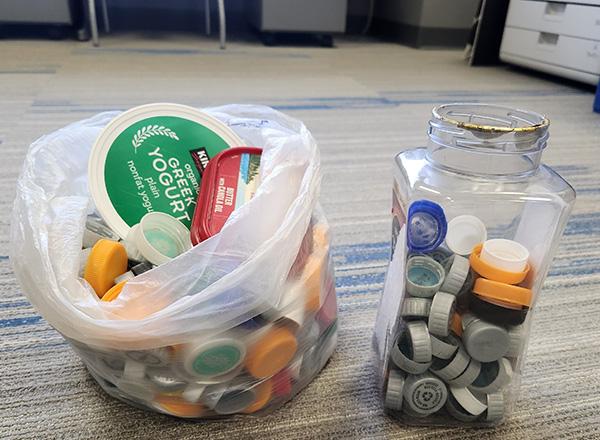 Collection of caps and lids in a bag and container. 