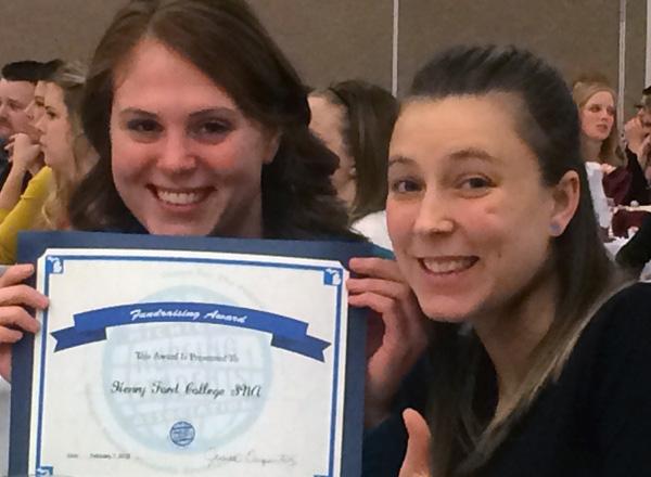 Students holding award certificate