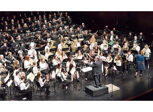 photo of Goward leading the band at a concert 
