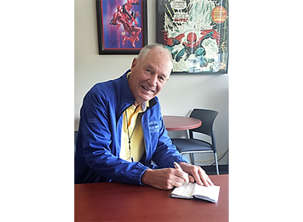 Photo of John Carroll at desk