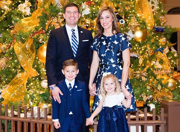 Photo of Kavalhuna family in front of a decorated tree