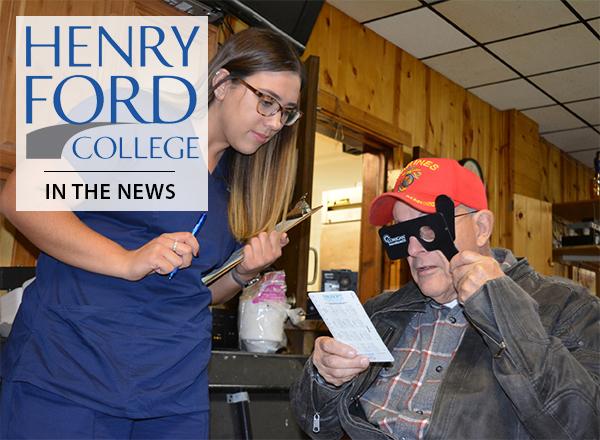 Female ophthalmic tech student standing near veteran undergoing eye exam