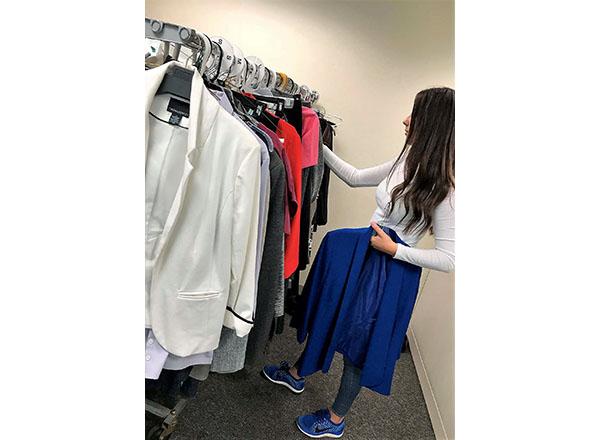 photo of young lady sorting through professional clothes in CSO
