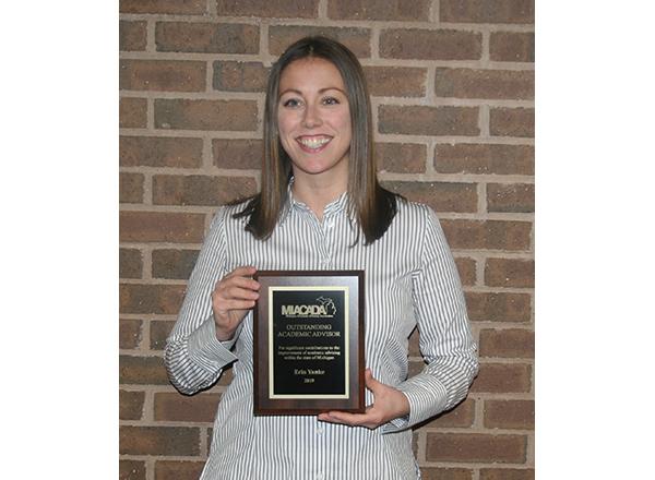 Erin Yanke holding her award