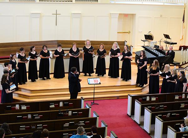 Women standing in a row, singing