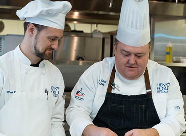 Chef Click with student in the HFC culinary kitchen