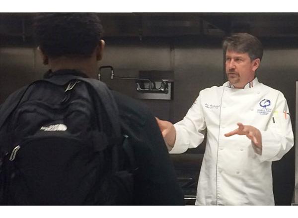 Photo of Eric Gackenbach speaking to students