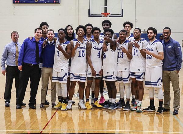 Photo of men's team with coaches standing in gym