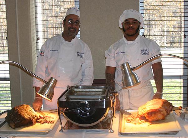 photo of 2 culinary students at their food stations 