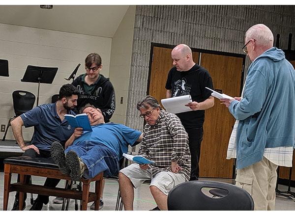 Action shot of 6 actors rehearsing