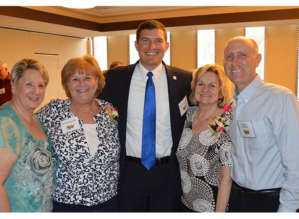 Group shot of President Kavalhuna and 4 retirees.