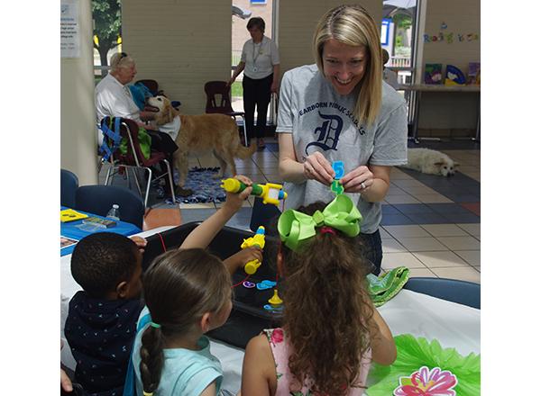 Photo of a woman leading craft activities