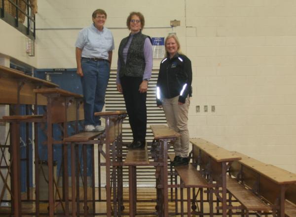 Bryden, Perkovich, and Schoen standing on the old bleachers