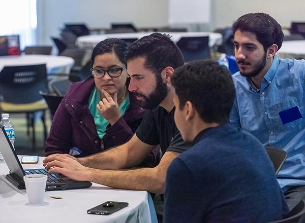 students gathered around a computer