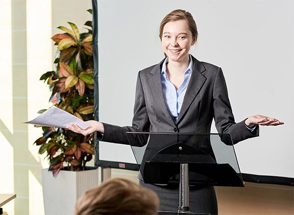 Woman speaking behind podium