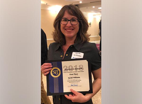 Headshot of Sarah Williams holding her SPJ award