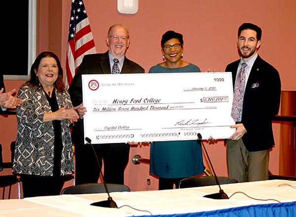 Large check presentation with board and legislators