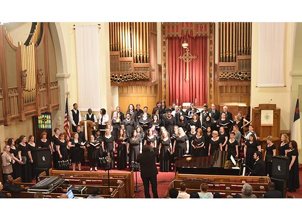 large group shot with Dewey leading the choir 