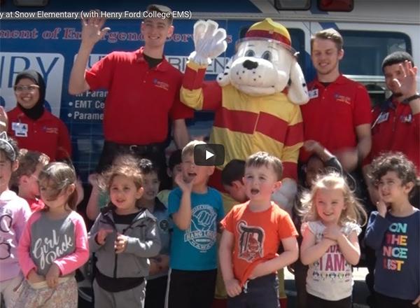 Photo of HFC students and Sparky the Fire Dog with Snow Elementary students.