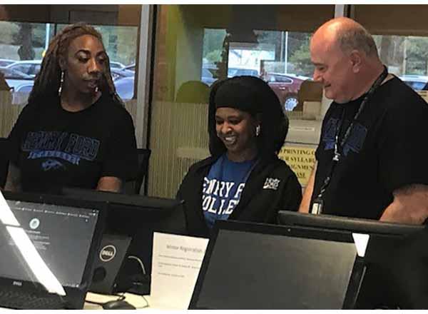 Photo of 3 people in computer lab