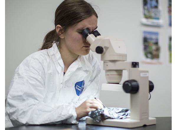 Woman looking into a microscope