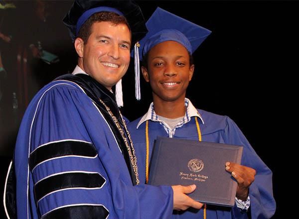 An image of Ismaila Ba with President Russ Kavalhuna.